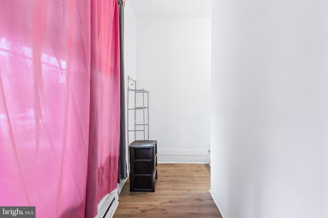 corridor with hardwood / wood-style flooring