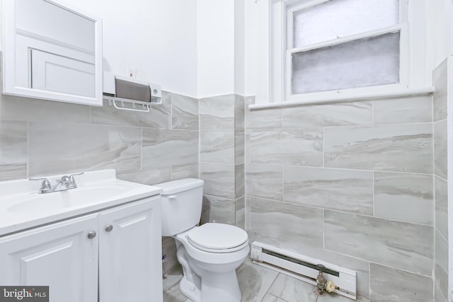 bathroom featuring tile walls, a baseboard heating unit, vanity, and toilet