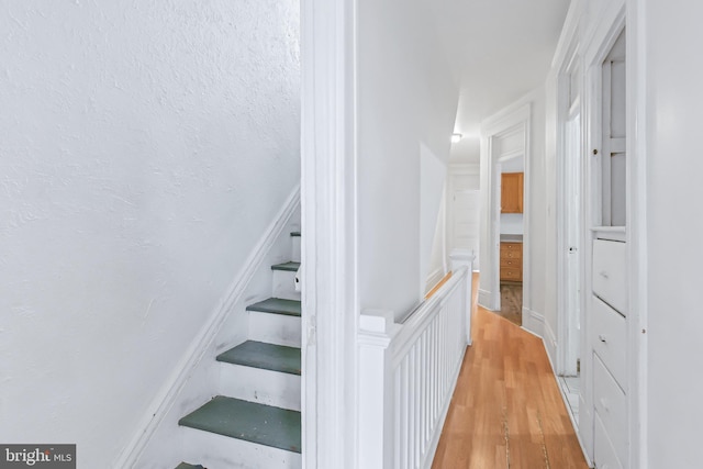 stairs featuring hardwood / wood-style floors