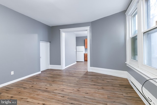 unfurnished room with hardwood / wood-style flooring