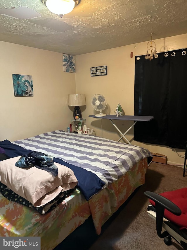 carpeted bedroom with a textured ceiling