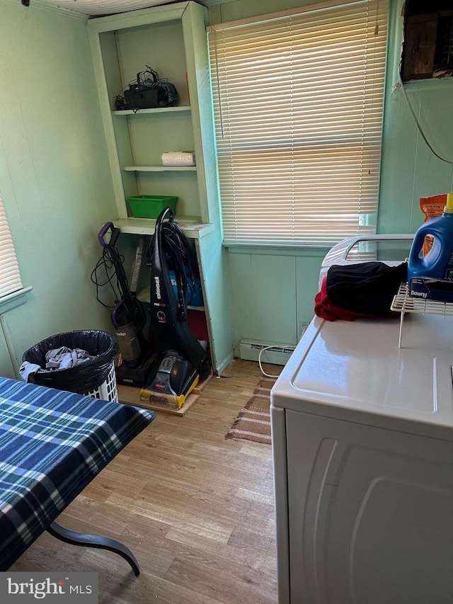 washroom with washer / dryer, a baseboard heating unit, and light hardwood / wood-style floors