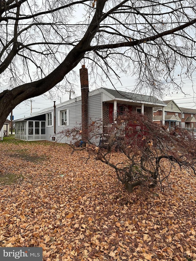 view of home's exterior featuring a sunroom