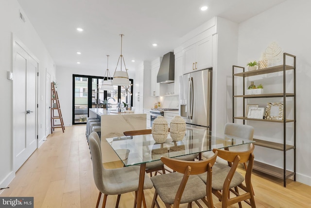 dining space with sink and light wood-type flooring