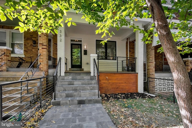 view of exterior entry with covered porch