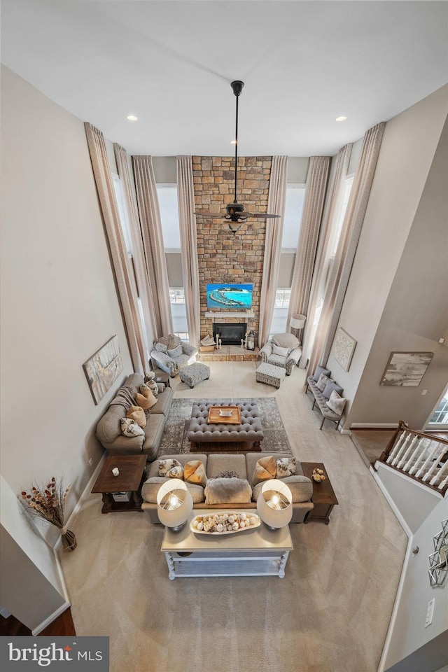 unfurnished living room featuring carpet floors, a fireplace, and a healthy amount of sunlight