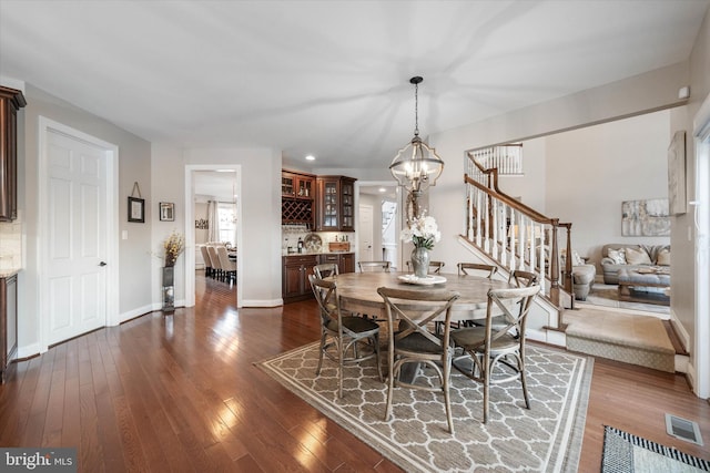 dining area featuring an inviting chandelier and dark hardwood / wood-style floors