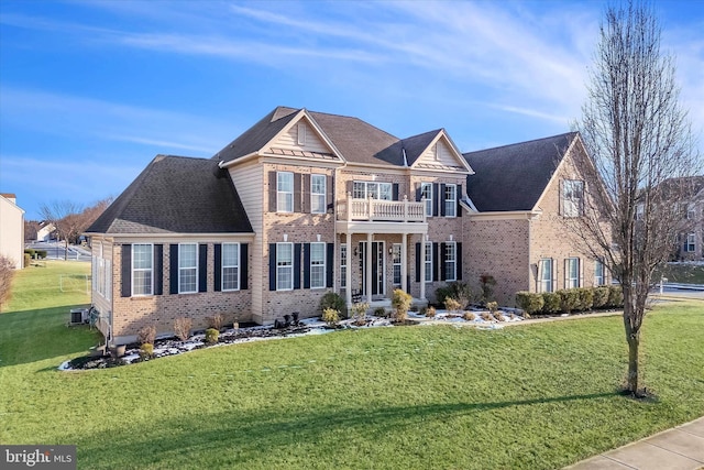 view of front of home featuring a front yard and a balcony