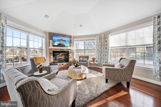 sunroom featuring lofted ceiling and a fireplace