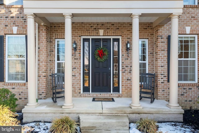 entrance to property featuring a porch