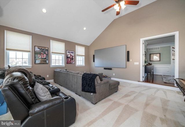 carpeted cinema featuring ceiling fan, a healthy amount of sunlight, and high vaulted ceiling