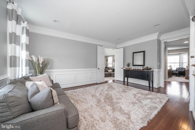 living room with ornamental molding and dark hardwood / wood-style flooring