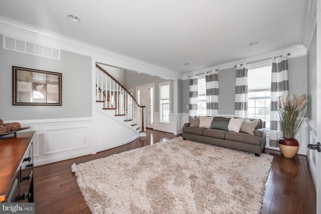 living room featuring crown molding and dark hardwood / wood-style floors