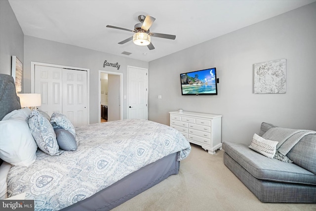 carpeted bedroom with ceiling fan and a closet