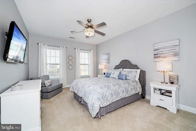 bedroom featuring light colored carpet and ceiling fan