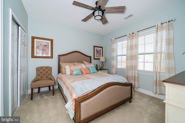 bedroom with light colored carpet, a closet, and ceiling fan