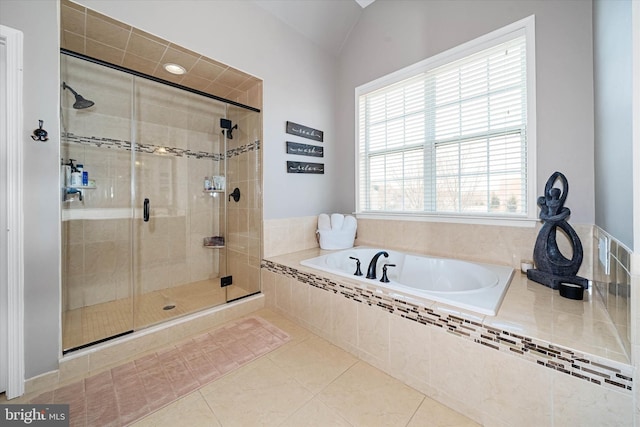 bathroom featuring independent shower and bath, vaulted ceiling, and tile patterned flooring