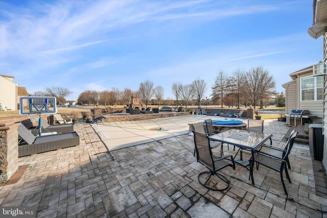 view of patio / terrace featuring area for grilling and a covered pool