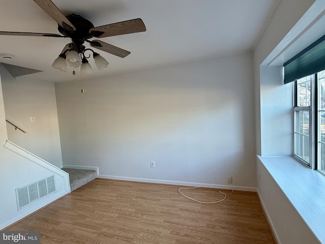 empty room with ceiling fan and light wood-type flooring