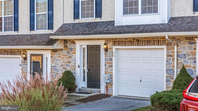 doorway to property with a garage