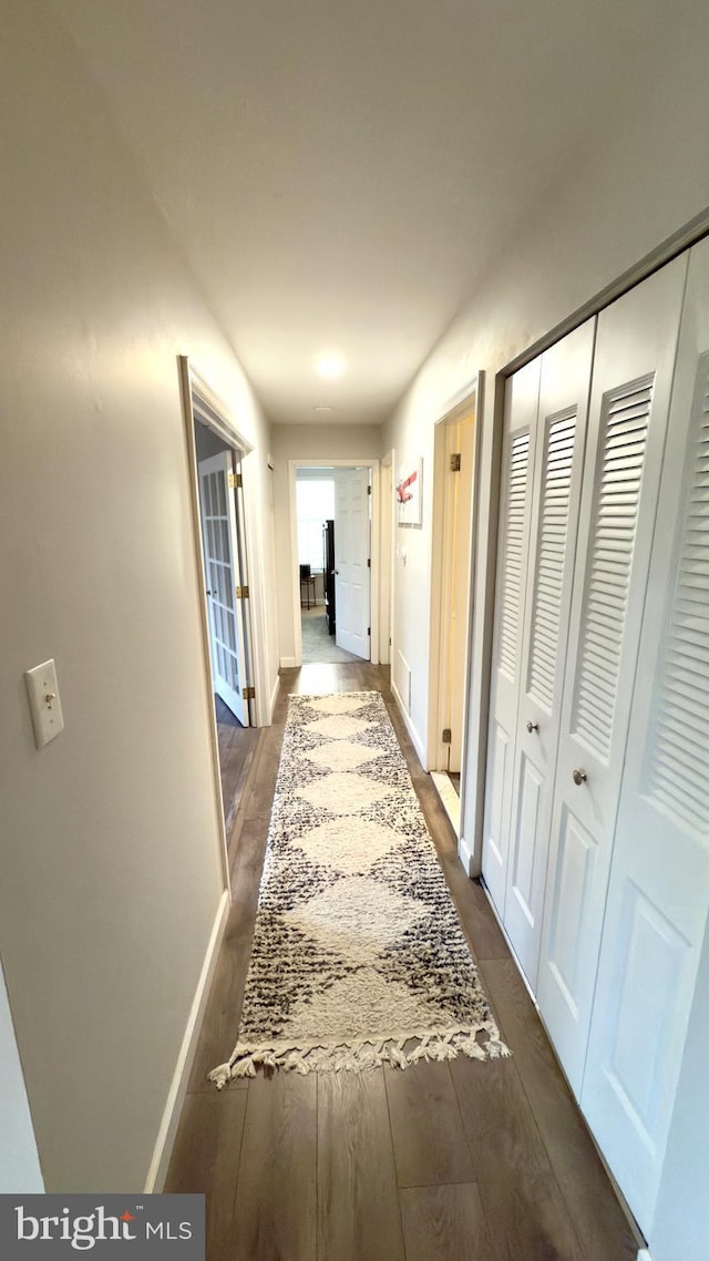 hall with dark hardwood / wood-style flooring