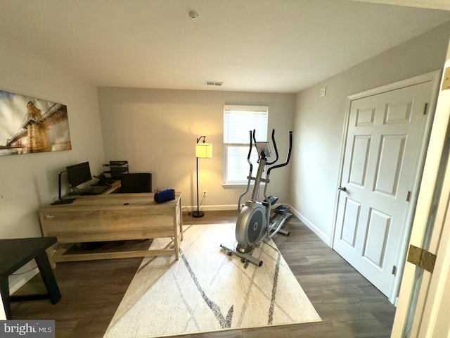 workout room with dark wood-type flooring