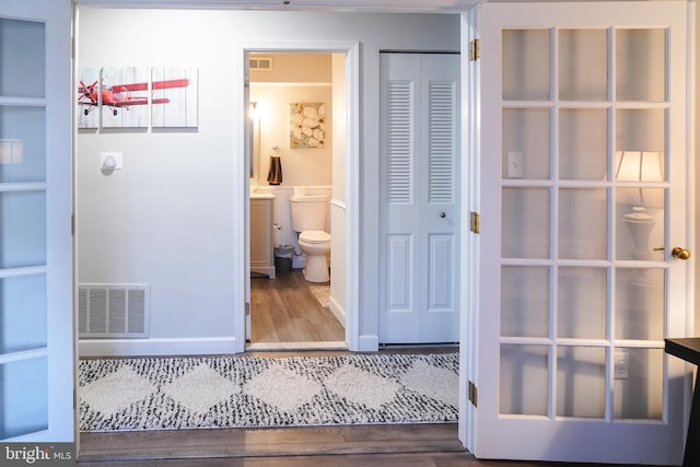 bathroom with hardwood / wood-style floors and toilet