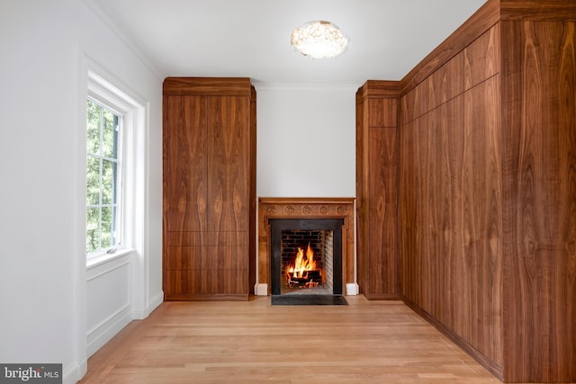 87 Library Pl, Princeton, NJ 08540 - unfurnished living room with light wood-style floors, a fireplace with flush hearth, and crown molding