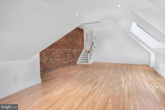 87 Library Pl, Princeton, NJ 08540 - bonus room with a skylight, wood finished floors, lofted ceiling, brick wall, and baseboards