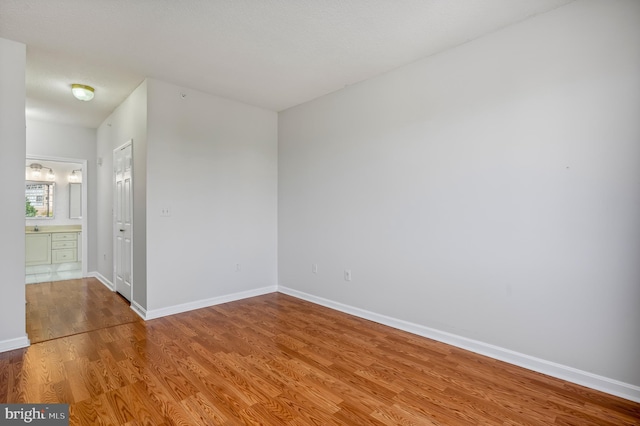 unfurnished room with hardwood / wood-style flooring