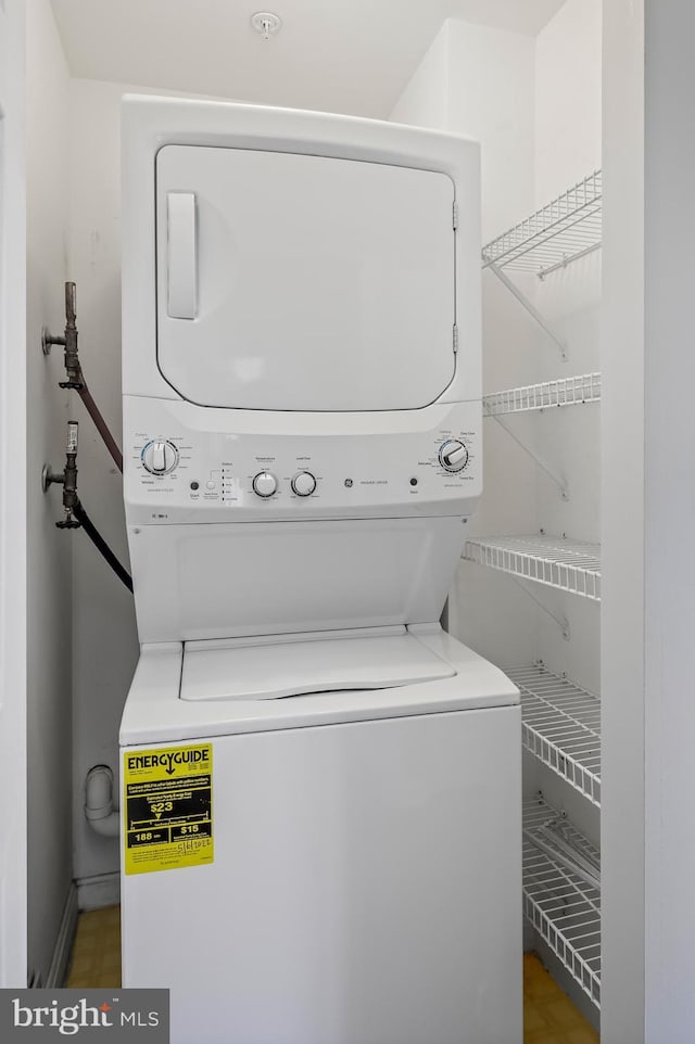 laundry room with stacked washer / dryer