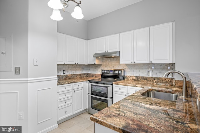 kitchen featuring white cabinetry, double oven range, hanging light fixtures, and sink