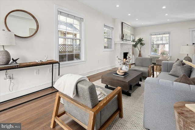 living room with light wood-type flooring and a fireplace