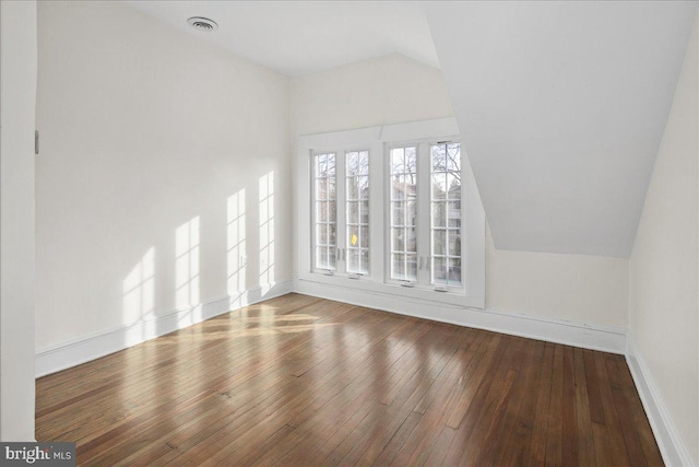 interior space with lofted ceiling and hardwood / wood-style floors