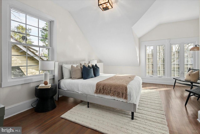 bedroom with vaulted ceiling and hardwood / wood-style floors