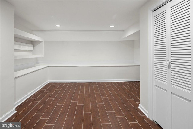 basement with dark hardwood / wood-style floors