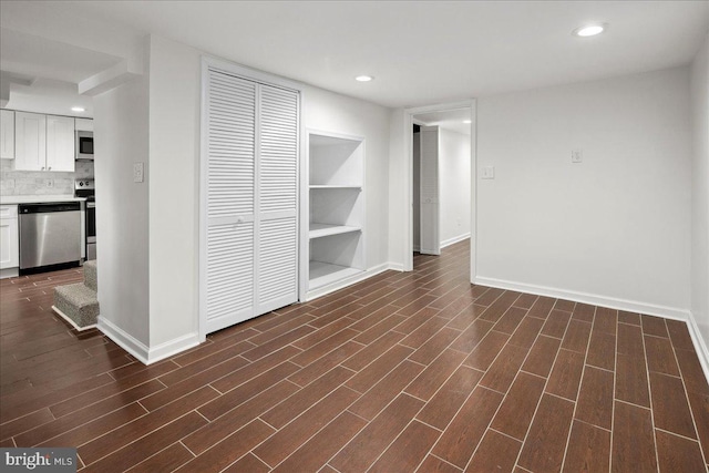 unfurnished living room with dark hardwood / wood-style flooring