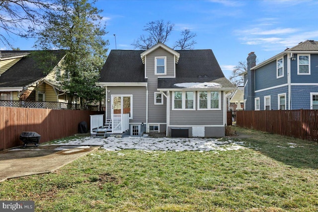 rear view of property with a yard