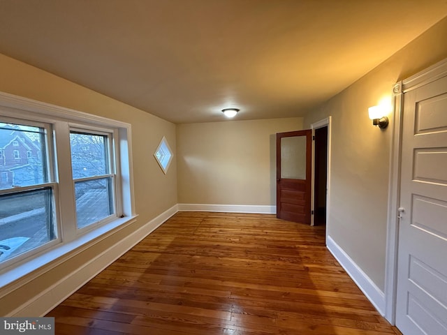 spare room with dark hardwood / wood-style flooring