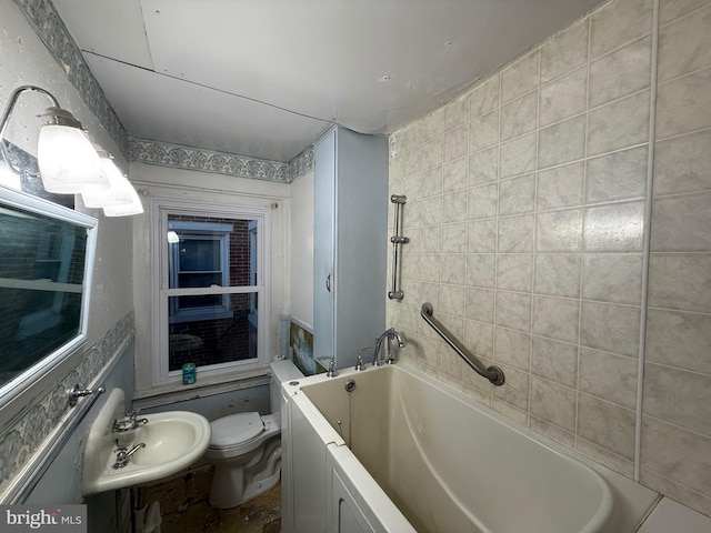 bathroom with toilet, a bathing tub, and sink