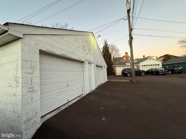 view of garage at dusk