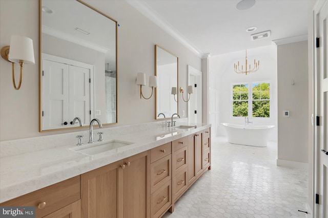 bathroom with a freestanding bath, crown molding, and a sink