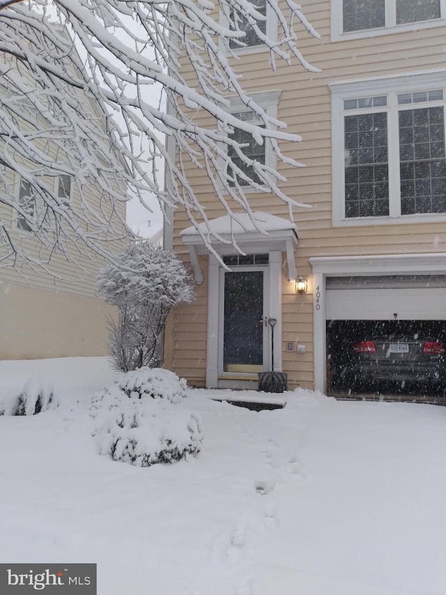 view of snow covered property entrance