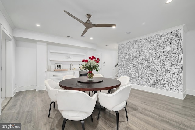 17-C Long Beach Blvd, Long Beach Township, NJ 08008 - dining space featuring light wood-style flooring, ceiling fan, wet bar, recessed lighting, and ornamental molding