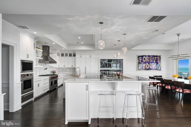 17-C Long Beach Blvd, Long Beach Township, NJ 08008 - kitchen with wall chimney range hood, stainless steel appliances, a raised ceiling, a warming drawer, and ornamental molding