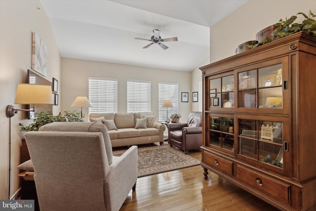 living room with vaulted ceiling, ceiling fan, and hardwood / wood-style floors