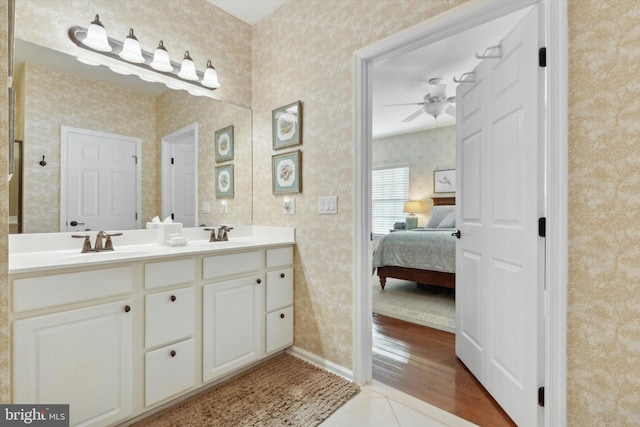 bathroom with tile patterned flooring, vanity, and ceiling fan