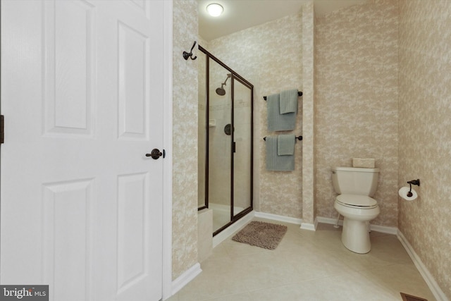 bathroom featuring walk in shower, tile patterned floors, and toilet