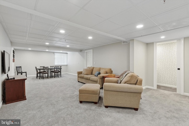 living room featuring light colored carpet and a drop ceiling