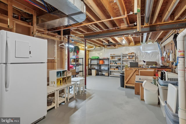 basement featuring white fridge